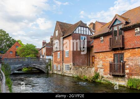 Der Fluss Itchen, der durch die Wehre in Winchester, Hampshire, Südengland fließt, sah in Richtung City Mill und der historischen Steinbrücke auf der Bridge Street Stockfoto