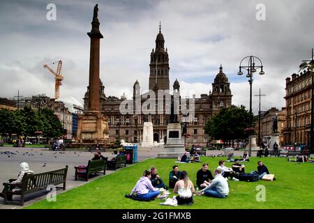 George Squuare, Hauptplatz, Säule mit Scott-Denkmal, Scott-Denkmal, Rathaus, Glasgow City Chambers, Park, Menschen im Park, Glasgow Stockfoto