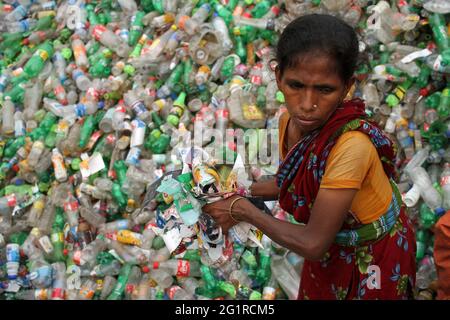 Dhaka, Dhaka, Bangladesch. Juni 2021. Eine Arbeiterin sortiert am 07. juni 2021 Plastikflaschen in einer Kunststoff-Recycling-Fabrik in Dhaka, Bangladesch. Sie erhält 1.5-2 US-Dollar pro Tag für ihre Arbeiten.das Recycling von Plastikflaschen hat sich in den letzten Jahren zu einem wachsenden Geschäft entwickelt und hilft, die Umwelt zu schützen. Quelle: Abu Sufian Jewel/ZUMA Wire/Alamy Live News Stockfoto