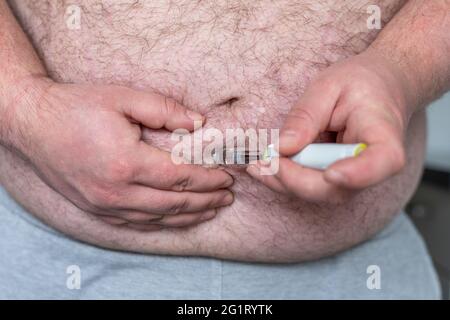 Fat Mann Hände machen Injektion mit Insulin-Stift oder Spritze, Medizin, Diabetes, Glykämie, Gesundheitsversorgung und Menschen Konzept. Stockfoto