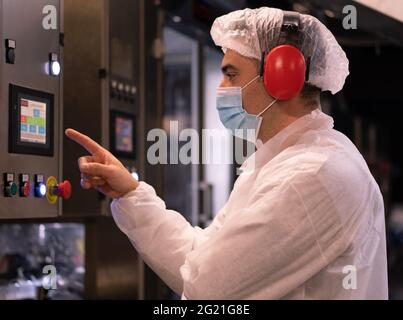 CAPUA, ITALIEN - 05. Jun 2021: Lebensmitteltechniker, der in einer lebensmittelverarbeitenden Fabrik arbeitet Stockfoto