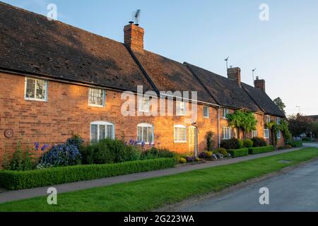 Sonnenaufgang über einer Reihe von Häuschen im oxfordshire Dorf Cropredy, Oxfordshire, England Stockfoto