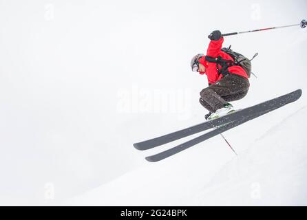 Springen auf verschneiten Hang Skifahrer Stockfoto