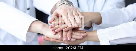 Gruppe von Ärzten, die ihre Hände zusammen in der Klinik Nahaufnahme Stockfoto