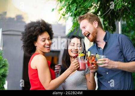 Multirassische Gruppe von Freunden, die Spaß haben und im Restaurant reden Stockfoto