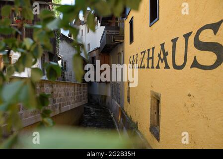 HALLSTAT, ÖSTERREICH - 08. Jan 2021: Typisch österreichisches Alpenhaus mit hellen Blumen auf dem Balkon Stockfoto