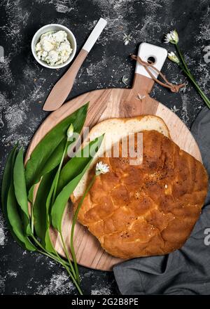 Frisch gebackenes hausgemachtes Fladenbrot mit cremigem Dip, frischen Bärlauch-Blättern Stockfoto