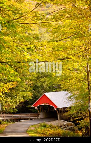 Red Covered Bridge eingebettet in Herbstlaub, Franconia Notch State Park, Flume Gorge, Lincoln, New Hampshire Stockfoto