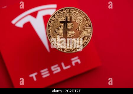 LONDON, Großbritannien - 2021. Juni: Bitcoin-Kryptowährung auf einem Tesla-Elektrofahrzeug-Logo Stockfoto