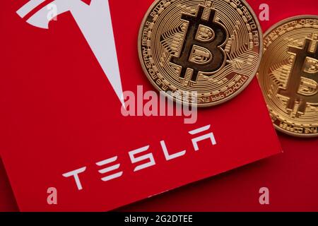 LONDON, Großbritannien - 2021. Juni: Bitcoin-Kryptowährung auf einem Tesla-Elektrofahrzeug-Logo Stockfoto