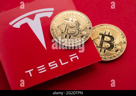 LONDON, Großbritannien - 2021. Juni: Bitcoin-Kryptowährung auf einem Tesla-Elektrofahrzeug-Logo Stockfoto