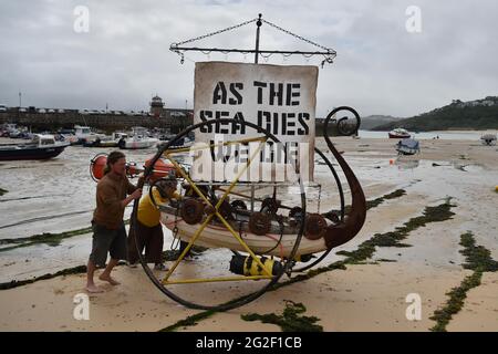 Die Demonstranten des Extinction Rebellion am Strand von St. Ives während des G7-Gipfels in Cornwall. Bilddatum: Freitag, 11. Juni 2021. Stockfoto