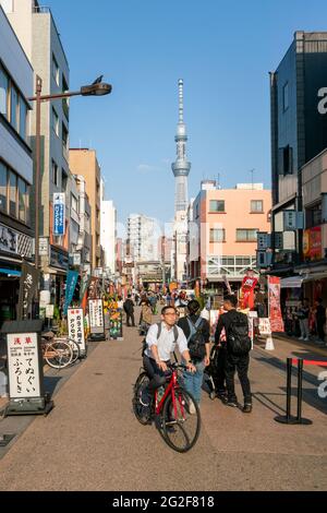 Tokio, Japan - 05.13.2019: Vertikale Aufnahme des Tokyo Sky Tree von der Straße zum Asakusa-Tempel an einem sonnigen Tag mit vielen Menschen Stockfoto