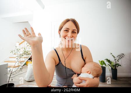 Porträt einer stillenden Mutter während eines Online-Meetings Stockfoto