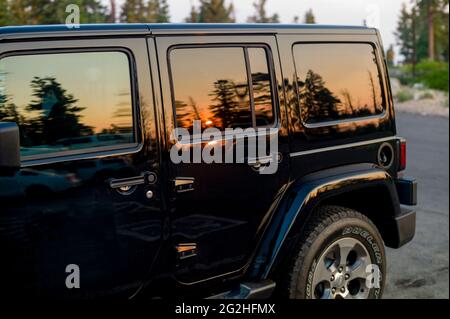 Spiegelung des Sonnenuntergangs am Fenster eines Jeeps auf dem Parkplatz nahe Rainbow Point im Bryce Canyon National Park, Utah, USA Stockfoto