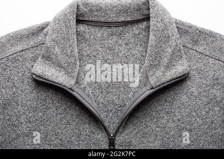 Graues Fleece Pullover Stoff Textur Mit Reißverschluss Auf Weißem Hintergrund Close Up. Stockfoto