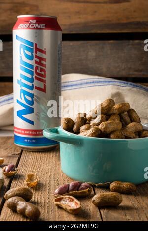 Natürliches helles Bier, hohe Dose mit Erdnüssen. Stockfoto