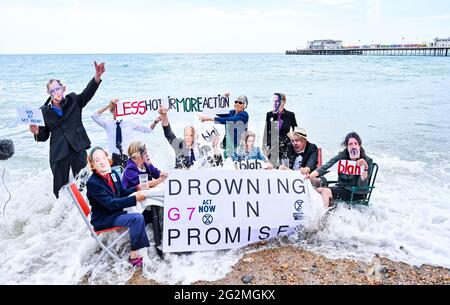 Worthing Sussex UK 12. Juni 2021 - Aktivisten des Extinction Rebellion werden im Meer nass, als sie heute an einem Protest am Worthing Beach teilnehmen, der im Rahmen eines Aktionswochenendes anlässlich des G7-Gipfels stattfindet und die Auswirkungen des Klimawandels und des steigenden Meeres beleuchtet Levels : Credit Simon Dack / Alamy Live News Stockfoto