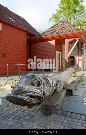 Große Holzschnitzereien eines Fisches an der historischen Hanseatic Wharf in Bergen. Ein UNESCO-Weltkulturerbe. Stockfoto