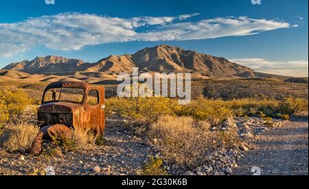 Altes Abholwrack, Sierra Parda (Little Chinati Peak) auf der rechten Seite, Chinati Peak auf der linken Seite, Chinati Mountains, Pinto Canyon Road, Big Bend Country, Texas Stockfoto