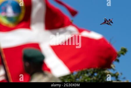 13. Juni 2021, Dänemark, Sønderborg: Auf der Düppeler Schanze (Kongeskansen Dybbøl Banke) bei Sønderborg (Sonderburg) fliegt ein dänisches Kampfflugzeug der Luftwaffe über die Zeremonie. Bundespräsident Steinmeier und seine Frau sind anlässlich des 100. Jahrestages der Grenzziehung zwischen Deutschland und Dänemark im Jahr 1920 zu einem zweitägigen Besuch in Dänemark. Die Feierlichkeiten mussten 2020 aus Corona-Gründen verschoben werden und werden nun wieder gutgemacht. Foto: Bernd von Jutrczenka/dpa Stockfoto