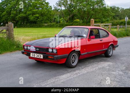 1986 80er Jahre roter Ford Capri 1993ccm Benzin-two​-plus-zwei Coupé beim 58. Jährlichen Manchester to Blackpool Vintage & Classic Car Run. Stockfoto