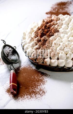 Hausgemachte glutenfreie Tiramisu traditionelle italienische Dessert mit Kakao bestreut Puder über weißem Marmortisch Stockfoto