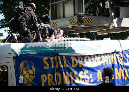 Ein Protestierender der Ausrottungsaufstand wird von der Polizei verhaftet, nachdem er einen Kreisverkehr mit einem Van in der Nähe des G7-Gipfelgeldes blockiert hat, was zu einer Umleitung des Verkehrs führt. Umweltproteste versammeln sich in Cornwall, während der britische Premierminister Boris Johnson beim G7-Gipfel in Carbis Bay führende Persönlichkeiten aus den USA, Japan, Deutschland, Frankreich, Italien und Kanada empfängt. In diesem Jahr hat das Vereinigte Königreich Australien, Indien, Südafrika und Südkorea eingeladen, als Gastländer sowie die EU am Gipfeltreffen der Staats- und Regierungschefs teilzunehmen. Protestgruppen hoffen, ihre verschiedenen Ursachen den G7-Führern und einem globalen Publikum als die Augen von t zu verdeutlichen Stockfoto