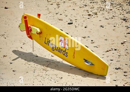 Saltburn-by-the-Sea, Küstenstadt in Redcar und Cleveland, North Yorkshire, England. Rettungsschwimmer Surfbrett am Strand Stockfoto