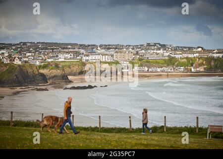 CORNISH Küstenstadt Newquay, Cornwall. Blick über Newquay Bay und Hundewanderer auf den Klippen Stockfoto