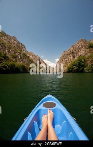 Kajak durch Fluss in Matka Canyon, Mazedonien. Frau Beine in der blauen Kajak Stockfoto