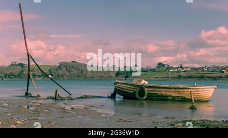 Verlassene Boot auf dem Fluss Torridge, rosa Sonnenuntergang. North Devon. Stockfoto