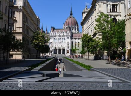 14. Juni 2021, Ungarn, Budapest: Touristen gehen aus dem Trianon-Denkmal, dem Nationaldenkmal, auf dem Lajos Kossuth Platz vor dem Parlament. Foto: Robert Michael/dpa-Zentralbild/dpa Stockfoto