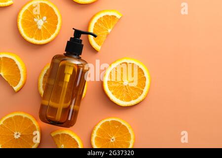 Shampoo-Flaschen aus bernsteinfarbenem Glas mit orangefarbener Ansicht von oben. SPA natürliche Fruchtkosmetik. Stockfoto