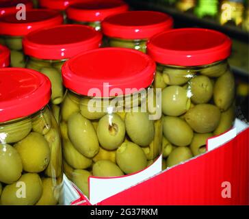 Eingelegte Oliven mit Gewürzen im Supermarkt.-Bild. Stockfoto