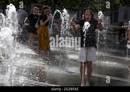 Moskau, Russland. 14. Juni 2021 WÄHREND des ungewöhnlich heißen Wetters in Moskau, Russland, BADET EIN junges Mädchen im Muzeon-Park am Krymskaja-Damm in einem Bodenbrunnen. Am 14. Juni erreichte die Temperatur in Moskau bis zu 27 Grad Stockfoto