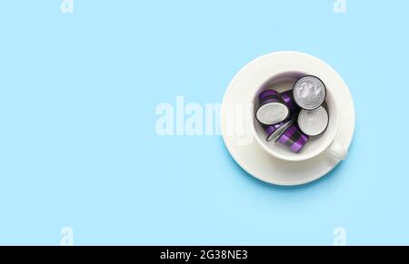 Tasse mit Kaffeekapseln auf farbigem Hintergrund Stockfoto