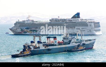 Kamtschatka, Russland - 14. Mai 2018: großes Kreuzfahrtschiff "Norwegian Jewel" und Meer Trawler "Borisov" an der Halbinsel Kamtschatka. Norwegian Jewel ist ein Kreuzfahrtschiff Stockfoto