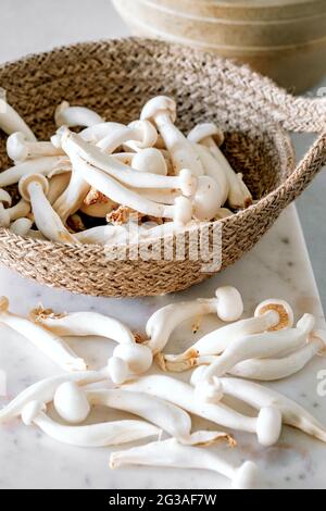 Weißer asiatischer Enoki-Pilz, rohes veganes Essen, Pilz, Nahaufnahme Stockfoto