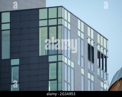 Modernes Bürogebäude in Parallelepipform mit großen Fenstern im Stadtzentrum Stockfoto