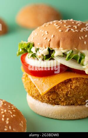 Knuspriger Chicken Burger auf grünem Hintergrund Stockfoto