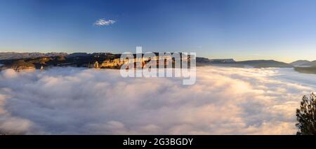 Sonnenaufgang mit einem Meer von Wolken über dem Stausee von Sau, mit Blick auf die Klippen von Tavertet. Von der Roca del Migdia, Osona, Barcelona, Katalonien, Spanien aus gesehen Stockfoto