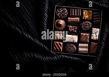 Schweizer Pralinen in Geschenkbox, verschiedene Luxus-Pralinen aus dunkler und milcher Bio-Schokolade in der Schweizer Chocolaterie, süße Dessertspeisen wie Stockfoto