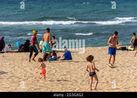 Kinder spielen Fußball am Strand, Sommerferien, Kinder haben Spaß. Stockfoto