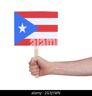 Hand hält kleine Karte - Flagge von Puerto Rico Stockfoto