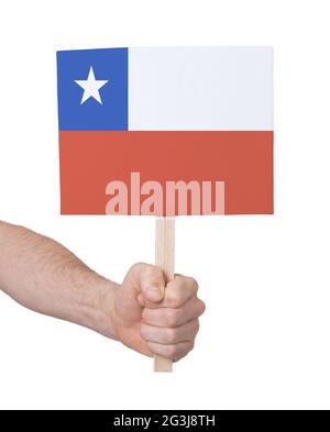 Hand hält kleine Karte - Flagge von Chile Stockfoto