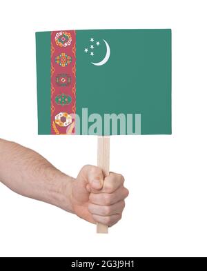 Hand mit kleiner Karte - Flagge von Turkmenistan Stockfoto