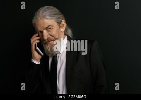 Stilvolles, altes männliches Telefongespräch auf dem Handy. Stockfoto