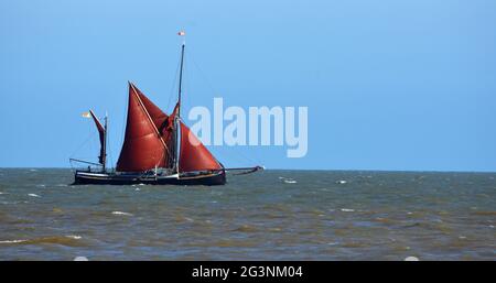 Red Sailed Barge segelt direkt vor der Küste von Suffolk. Stockfoto