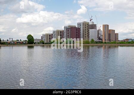 Blick auf neue Wohnhäuser Wohnapartments Wohnblocks im Bau und Walthamstow Wetlands Wildlife Reservoir in London N17 England Großbritannien Stockfoto